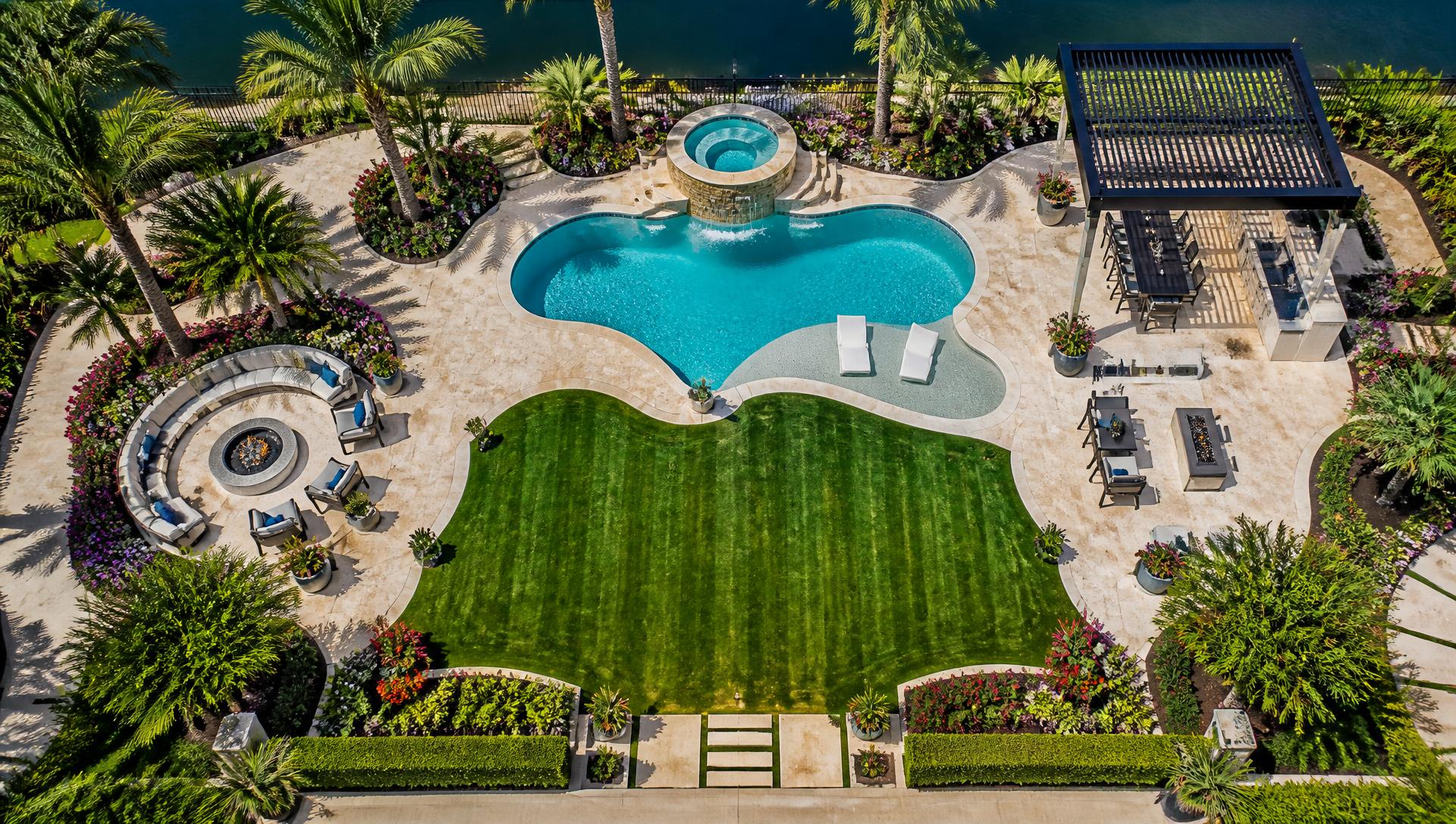 Aerial drone view of a resort style backyard with freeform pool